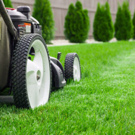 close up of lawn mower mowing grass. Utah landscaping concept